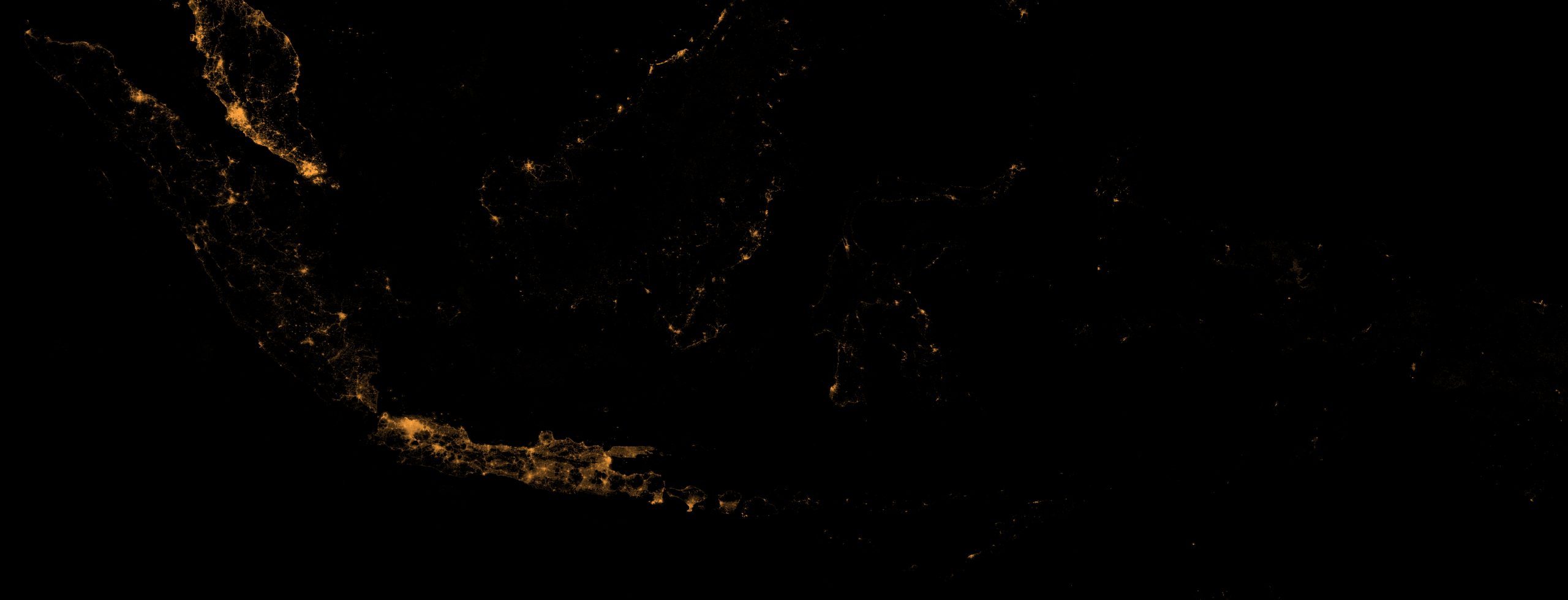 Indonesia at night, 2026-07 — NASA Black Marble radiance rendered in amber